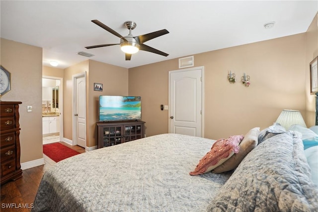 bedroom with baseboards, visible vents, a ceiling fan, dark wood finished floors, and connected bathroom