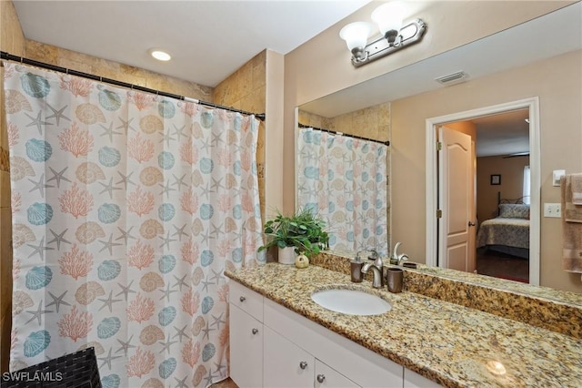 ensuite bathroom featuring a shower with curtain, ensuite bath, visible vents, and vanity