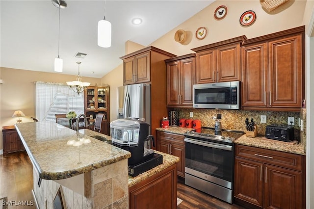 kitchen with stainless steel appliances, a sink, vaulted ceiling, backsplash, and dark wood-style floors