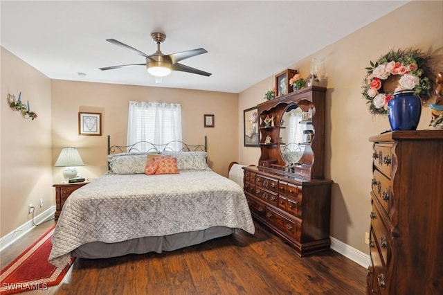 bedroom with a ceiling fan, baseboards, and wood finished floors