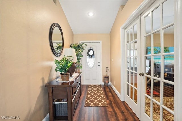 doorway to outside featuring baseboards, dark wood finished floors, and french doors