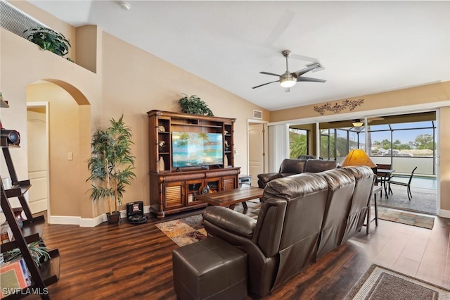 living area featuring arched walkways, dark wood-style flooring, vaulted ceiling, ceiling fan, and baseboards