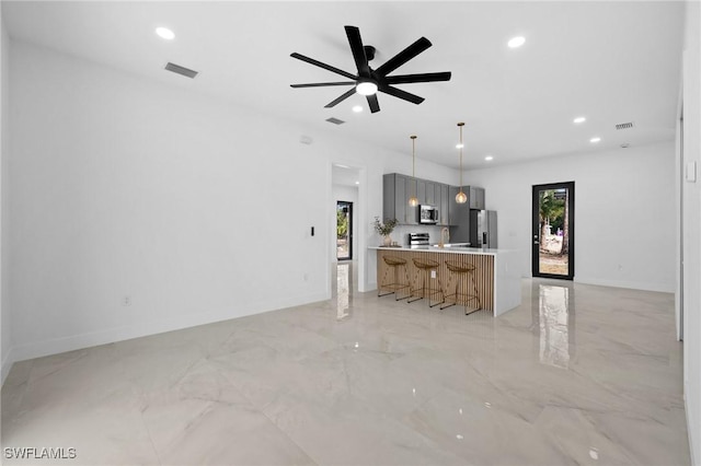 unfurnished living room featuring baseboards, visible vents, and recessed lighting