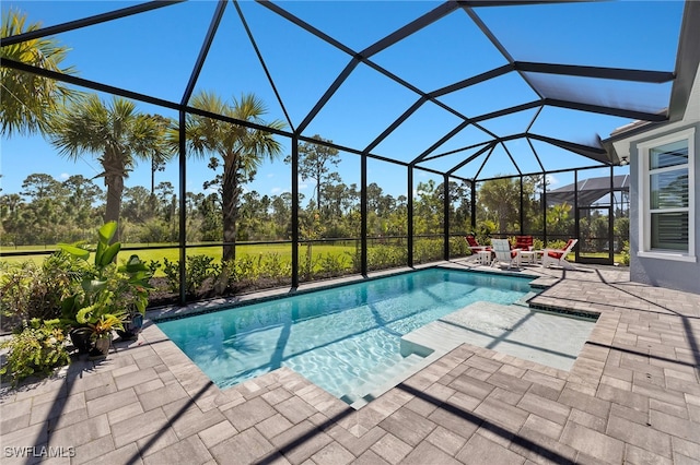 pool featuring glass enclosure and a patio