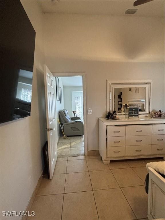 bathroom with tile patterned flooring, visible vents, and baseboards