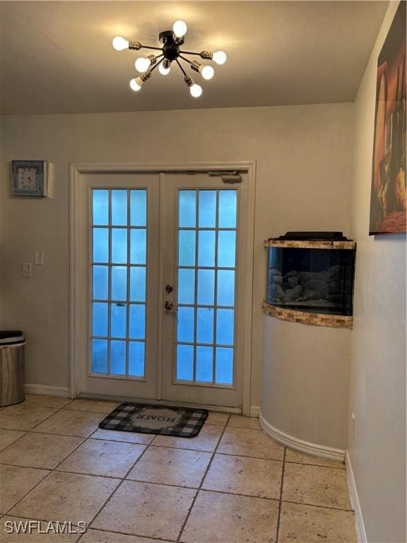 doorway to outside with baseboards and french doors