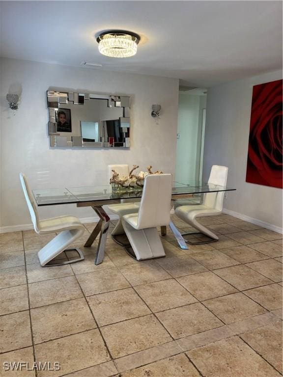 tiled dining room with baseboards