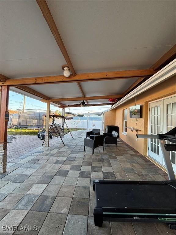 view of patio / terrace with french doors and a lanai