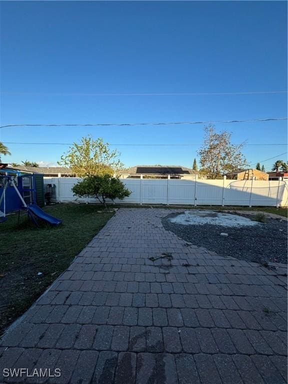 view of patio / terrace featuring a playground and a fenced backyard