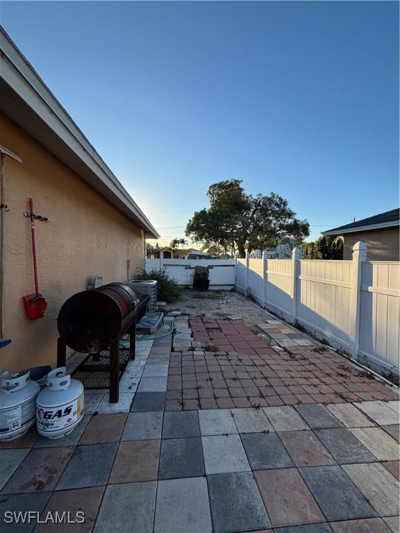 view of patio with a fenced backyard and a grill