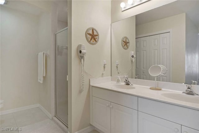 full bath with tile patterned flooring, a sink, a shower stall, and double vanity