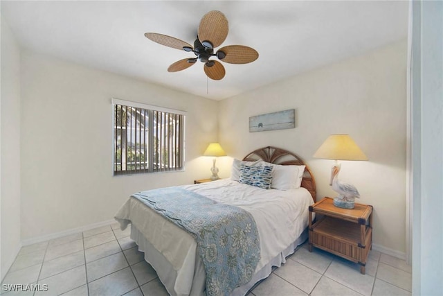 bedroom featuring light tile patterned floors, ceiling fan, and baseboards