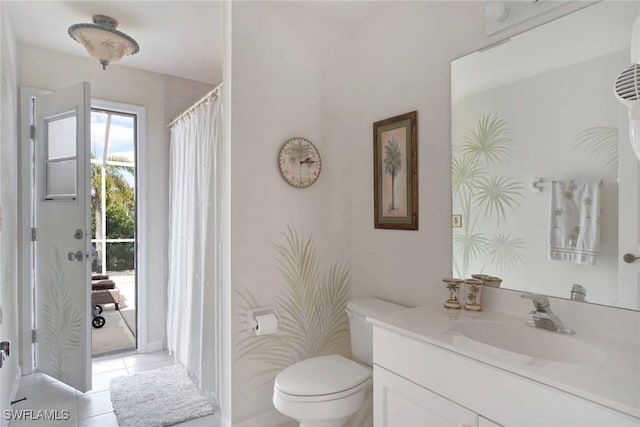 full bathroom featuring toilet, vanity, and tile patterned floors