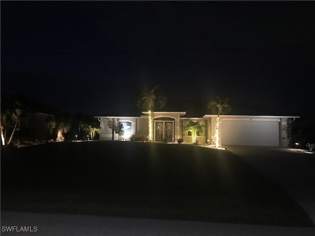 view of front of home with driveway and an attached garage