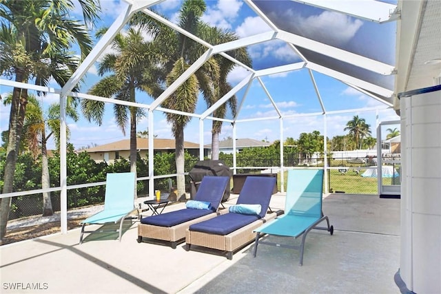 view of patio with glass enclosure