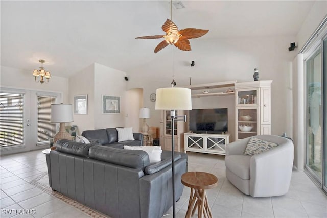 living area featuring visible vents, lofted ceiling, ceiling fan with notable chandelier, french doors, and light tile patterned flooring