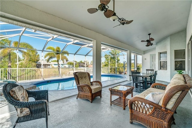 sunroom / solarium featuring lofted ceiling and ceiling fan