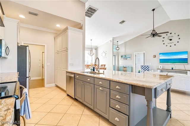 kitchen with visible vents, gray cabinetry, a sink, open floor plan, and appliances with stainless steel finishes