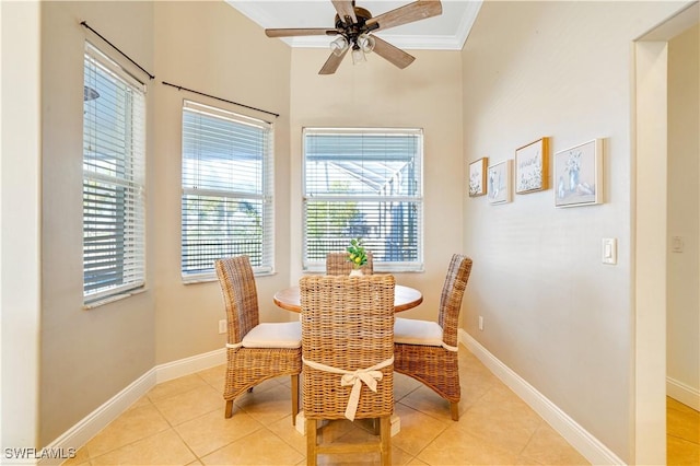 dining room featuring light tile patterned floors, baseboards, and crown molding