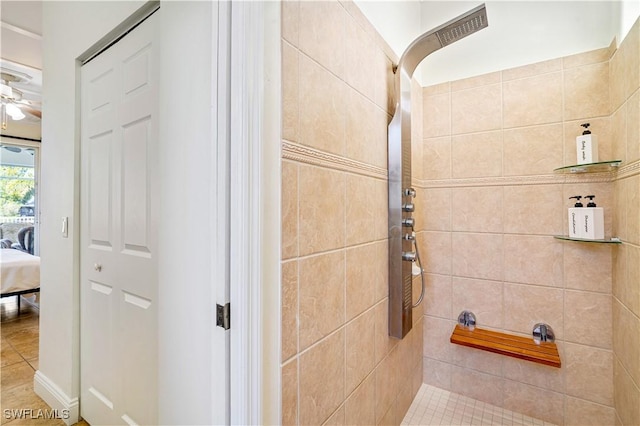 ensuite bathroom featuring a tile shower, connected bathroom, and a ceiling fan