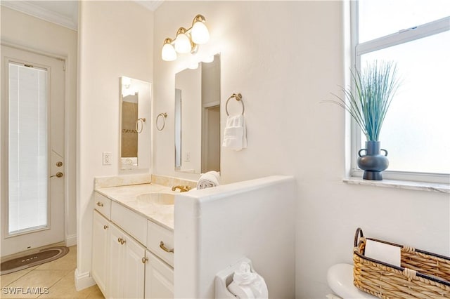 bathroom featuring vanity, tile patterned floors, crown molding, and a wealth of natural light
