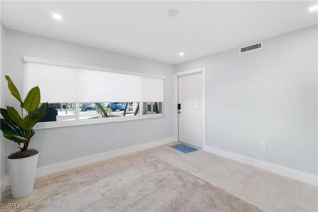 empty room with recessed lighting, visible vents, and baseboards