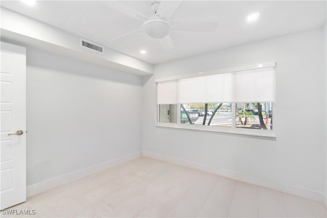 unfurnished room featuring a ceiling fan, visible vents, and baseboards