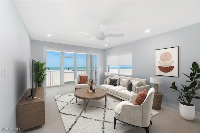 living room featuring ceiling fan, recessed lighting, and baseboards