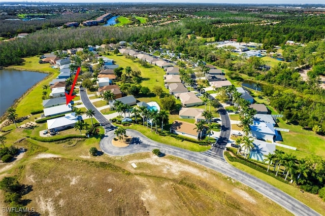 bird's eye view with a residential view and a water view