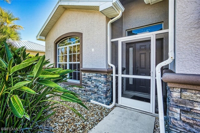 entrance to property with stucco siding