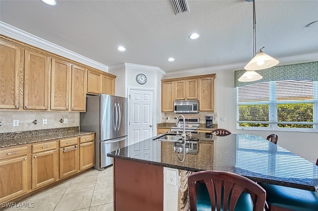 kitchen featuring appliances with stainless steel finishes, backsplash, a sink, and visible vents