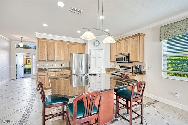 kitchen featuring tasteful backsplash, baseboards, visible vents, and stainless steel appliances