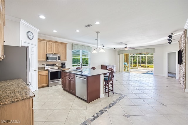 kitchen featuring light tile patterned floors, stainless steel appliances, a sink, visible vents, and open floor plan