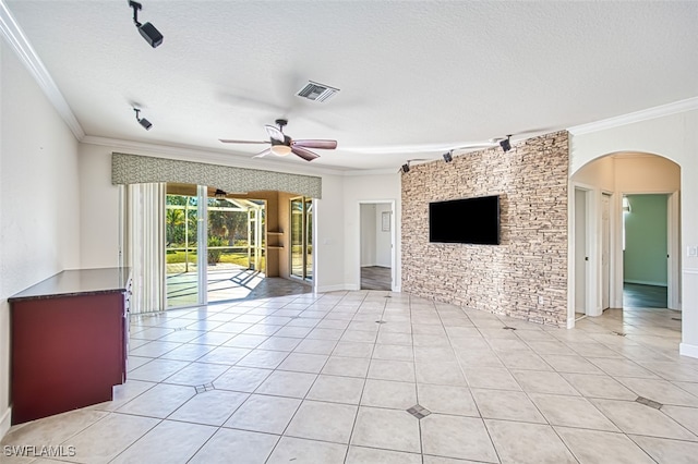 unfurnished living room with visible vents, arched walkways, and ornamental molding