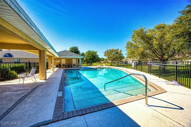 community pool featuring a patio area and fence