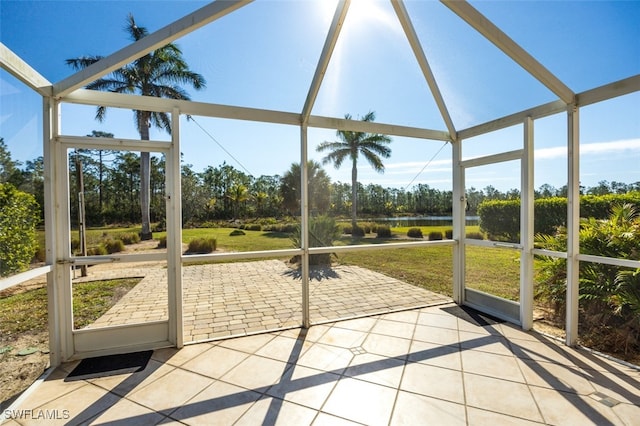 unfurnished sunroom with a water view