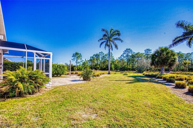 view of yard featuring a lanai and a patio