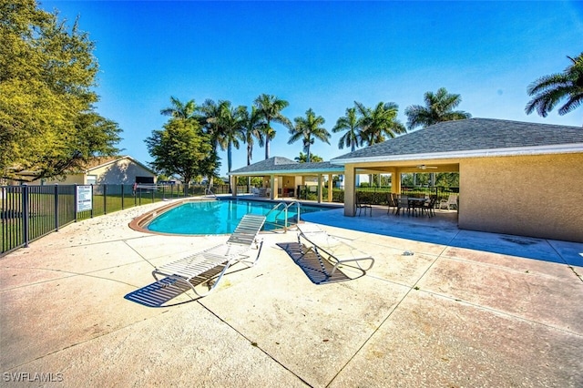 pool featuring a patio area and fence