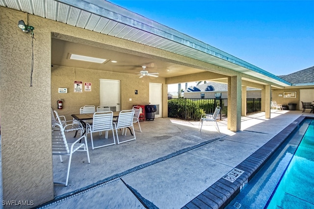 view of patio featuring ceiling fan, outdoor dining space, and a community pool