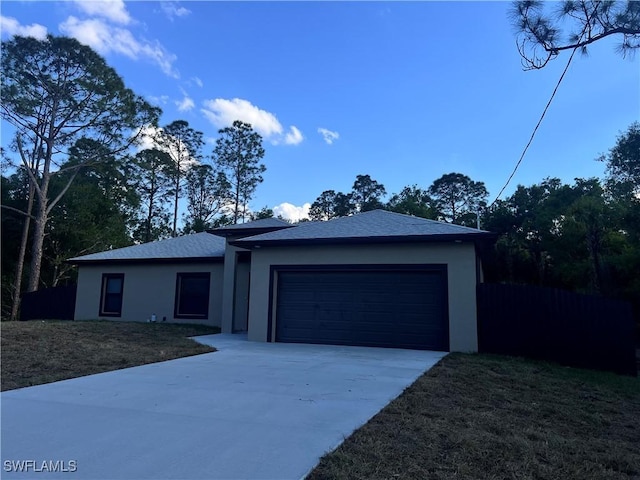 ranch-style home with a front lawn, driveway, an attached garage, and stucco siding