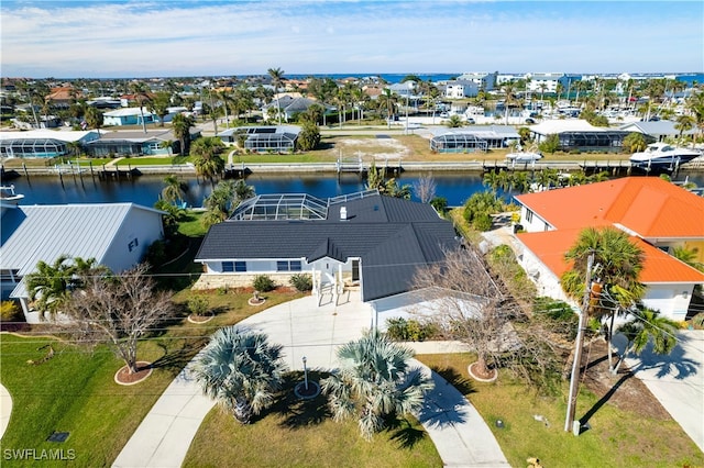 birds eye view of property featuring a water view and a residential view