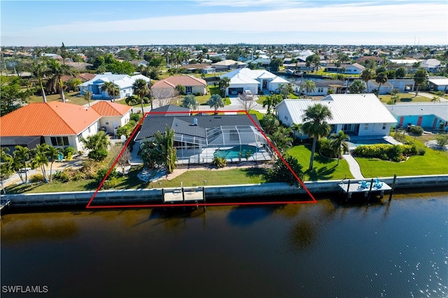 birds eye view of property with a water view and a residential view