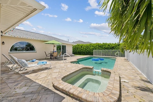 view of swimming pool with an in ground hot tub, a patio, a fenced backyard, and a fenced in pool