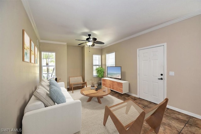 living area featuring baseboards, ornamental molding, and a ceiling fan