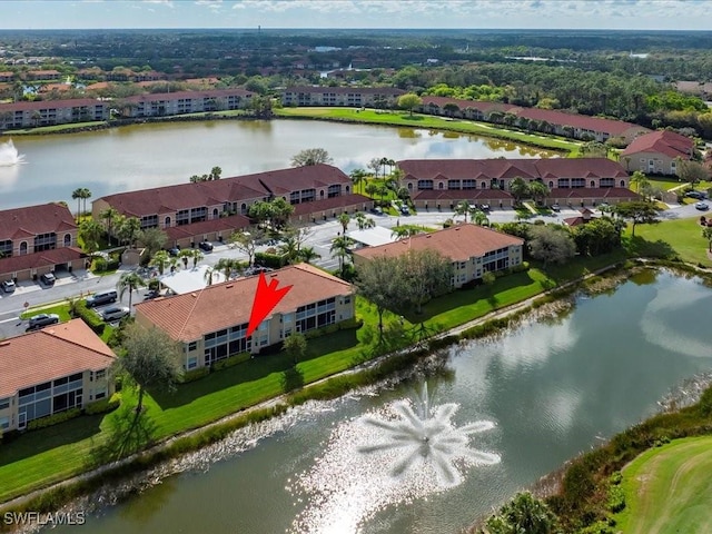 drone / aerial view with a water view and a residential view