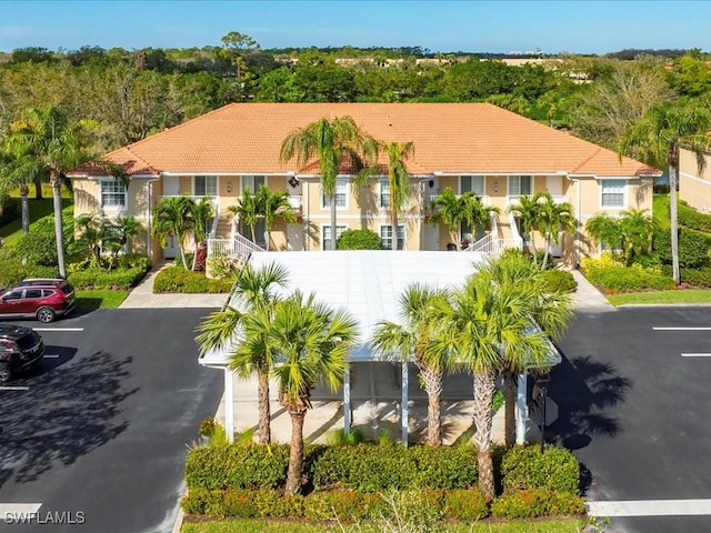 view of building exterior featuring a fenced front yard and uncovered parking