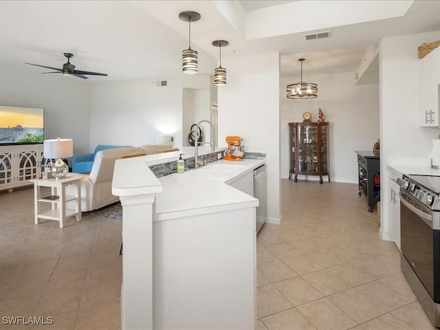 kitchen featuring light tile patterned flooring, a peninsula, range with electric stovetop, visible vents, and stainless steel dishwasher