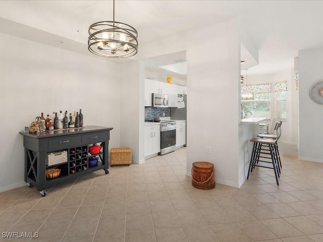 dining area featuring light tile patterned floors, baseboards, and an inviting chandelier