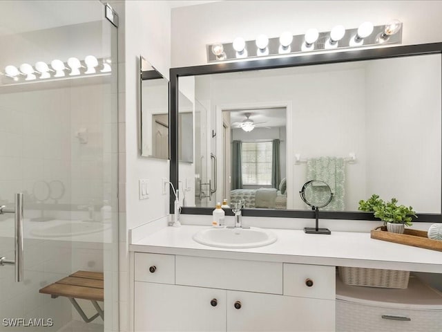 ensuite bathroom featuring a ceiling fan, ensuite bath, vanity, and a shower stall