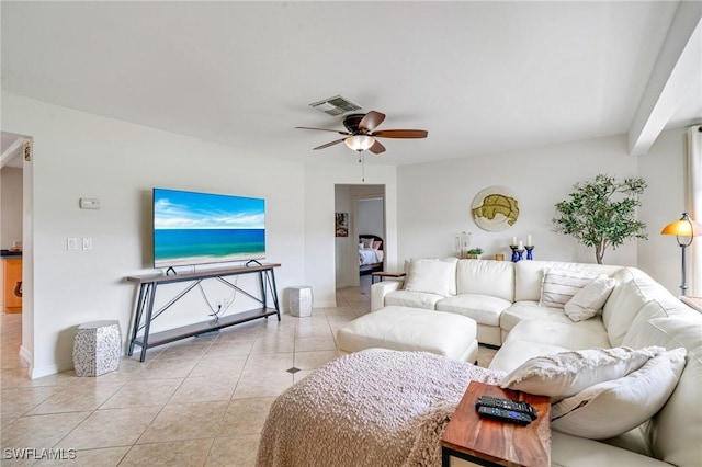 living room with light tile patterned floors, visible vents, and a ceiling fan